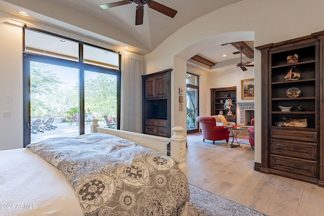 bedroom with access to exterior, vaulted ceiling, ceiling fan, and light wood-type flooring