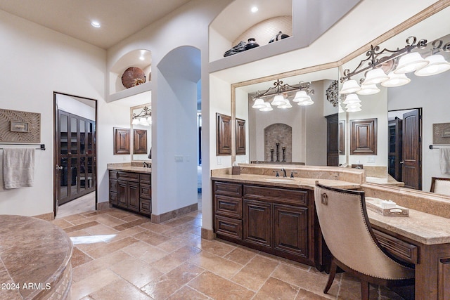 bathroom with vanity and a towering ceiling