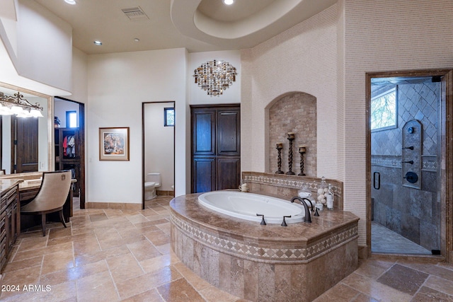 full bathroom with vanity, a towering ceiling, independent shower and bath, and toilet