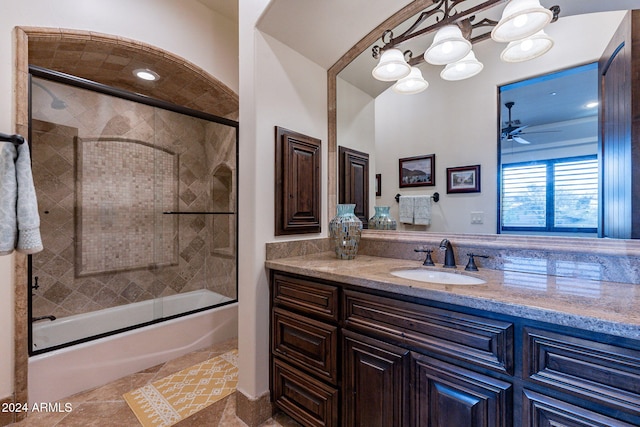 bathroom featuring tile patterned flooring, enclosed tub / shower combo, vanity, and ceiling fan