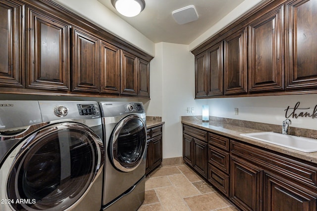 clothes washing area featuring cabinets, separate washer and dryer, and sink