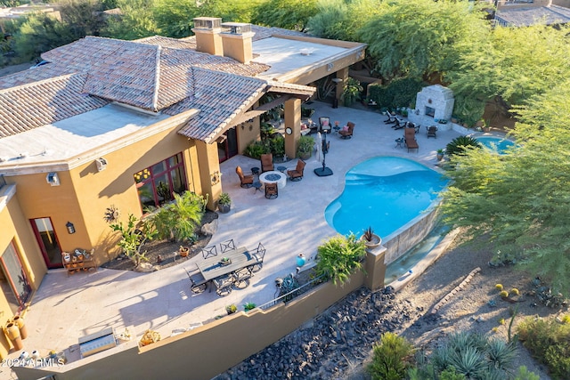 view of pool featuring a patio and an outdoor fire pit