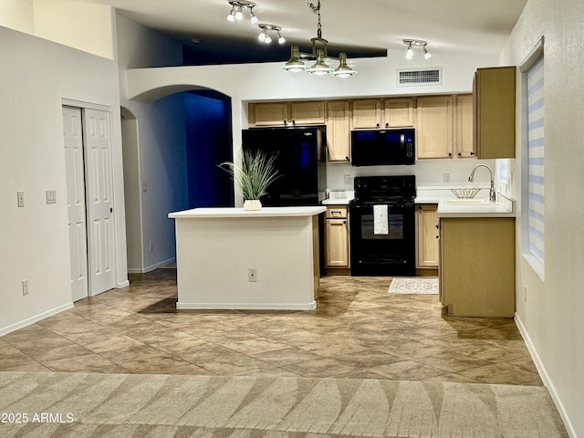 kitchen with visible vents, black appliances, a sink, arched walkways, and light countertops