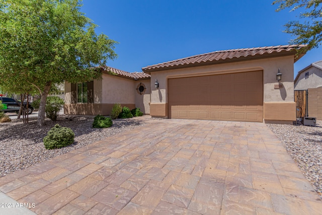 mediterranean / spanish house featuring a garage