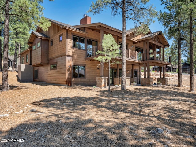 back of property featuring a balcony