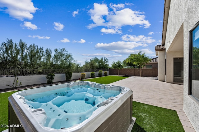 view of pool with a patio area, a lawn, a hot tub, and a fenced backyard