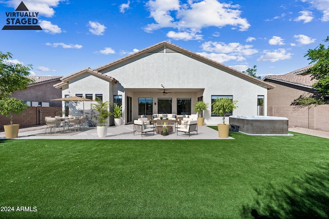 rear view of property featuring ceiling fan, a patio, fence, stucco siding, and a hot tub