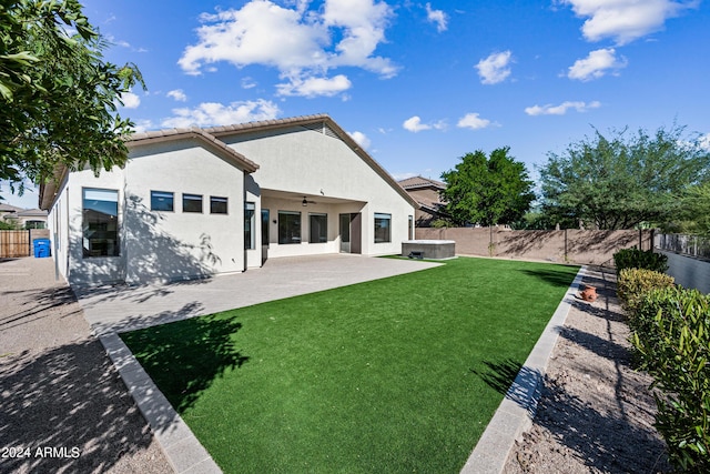 back of property with a yard, a patio, stucco siding, ceiling fan, and a fenced backyard