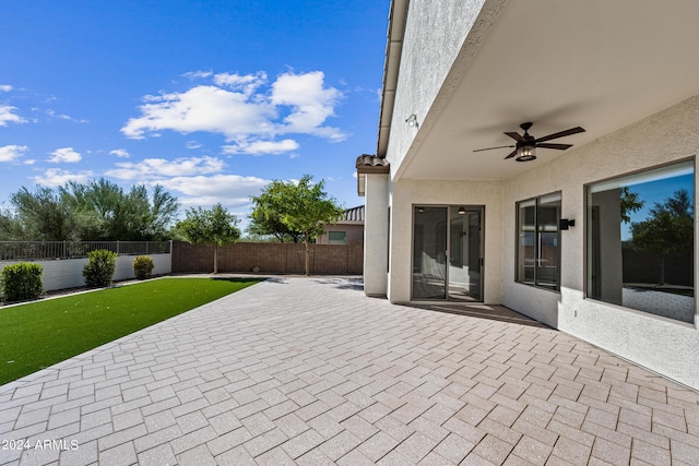 view of patio with a fenced backyard and a ceiling fan