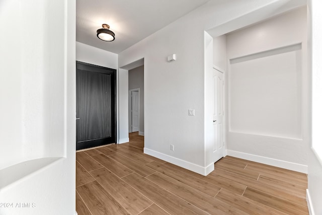 interior space with baseboards and light wood-style floors