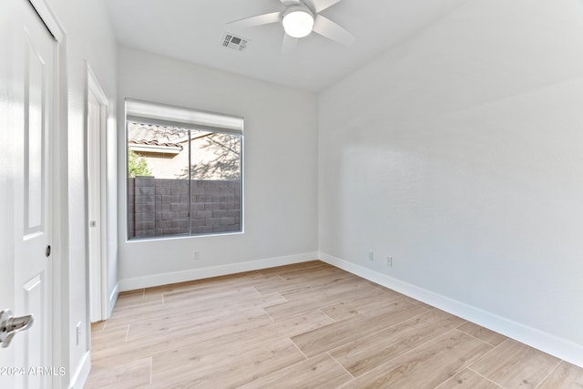 unfurnished room with baseboards, ceiling fan, visible vents, and light wood-style floors