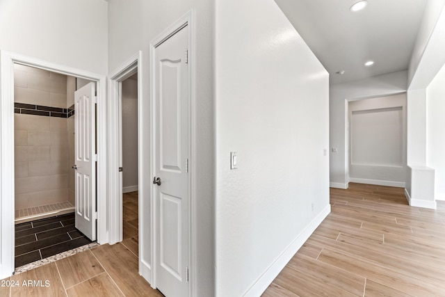 hall featuring baseboards, recessed lighting, and wood tiled floor