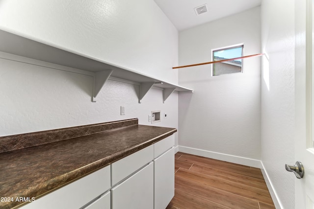 laundry area featuring washer hookup, wood finished floors, visible vents, baseboards, and electric dryer hookup