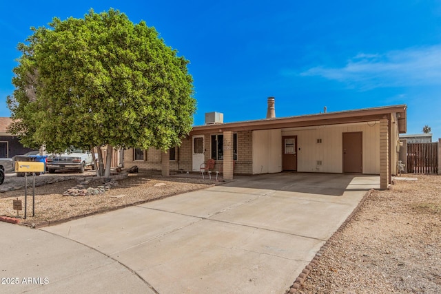 20053 N 15th Dr, Phoenix, AZ 85027 - ranch-style home with central air condition unit, fence, driveway, brick siding, and an attached carport