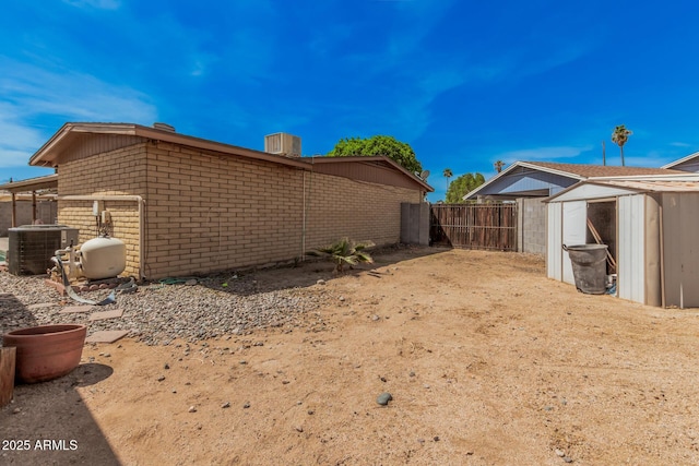 20053 N 15th Dr, Phoenix, AZ 85027 - view of yard with central AC unit, an outbuilding, a storage unit, and fence