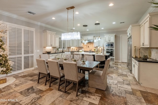 dining space with sink and ornamental molding