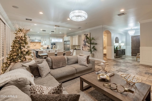 living room featuring ornamental molding and an inviting chandelier