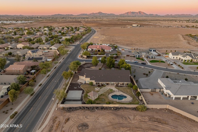 aerial view at dusk featuring a mountain view