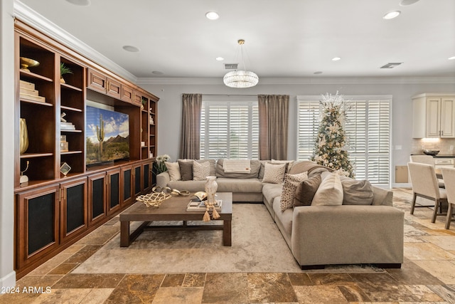 living room with crown molding and a notable chandelier