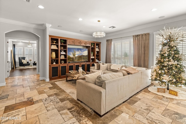 living room with ceiling fan and ornamental molding