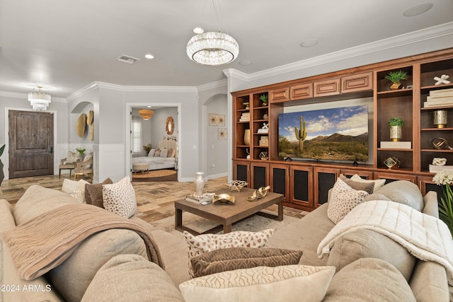 living room featuring ornamental molding and a notable chandelier