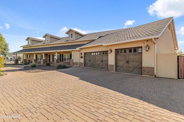 view of front of property with a porch and a garage