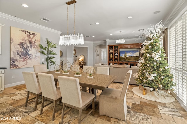 dining area featuring a chandelier and ornamental molding