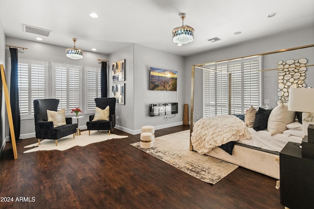 bedroom with a notable chandelier and wood-type flooring