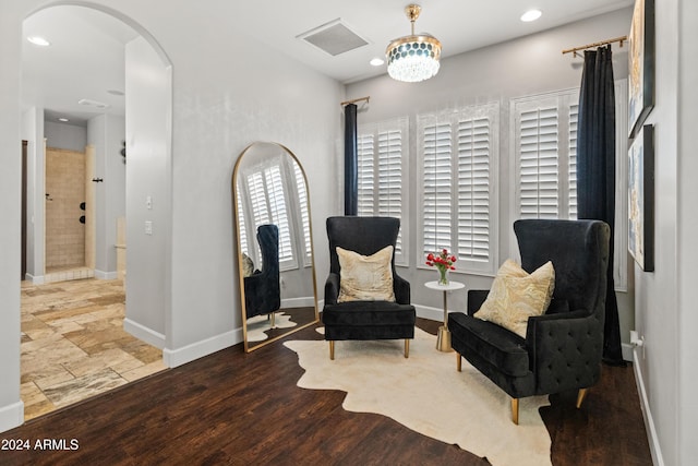 sitting room with a notable chandelier and light wood-type flooring