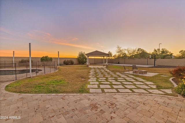 surrounding community with a gazebo, a yard, and a patio