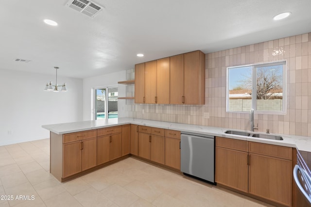 kitchen with tasteful backsplash, visible vents, stainless steel dishwasher, a sink, and a peninsula