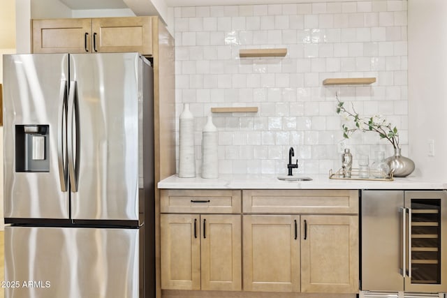 6761 E Juniper Ave, Scottsdale, AZ 85254 - kitchen with wine cooler, stainless steel refrigerator with ice dispenser, light brown cabinets, and a sink