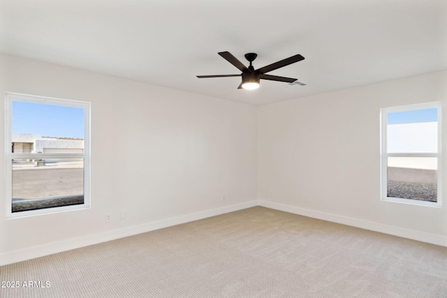 6761 E Juniper Ave, Scottsdale, AZ 85254 - empty room with light carpet, ceiling fan, baseboards, and a wealth of natural light