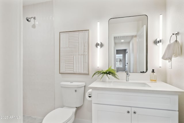 6761 E Juniper Ave, Scottsdale, AZ 85254 - full bathroom featuring vanity, a tile shower, and toilet