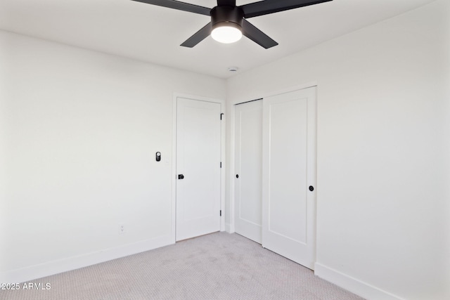 6761 E Juniper Ave, Scottsdale, AZ 85254 - unfurnished bedroom featuring a closet, baseboards, a ceiling fan, and light carpet