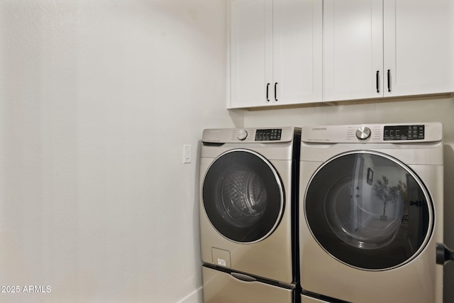 6761 E Juniper Ave, Scottsdale, AZ 85254 - washroom with baseboards, cabinet space, and washer and clothes dryer