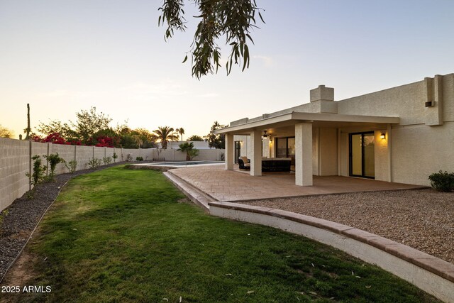 6761 E Juniper Ave, Scottsdale, AZ 85254 - yard at dusk with a fenced backyard and a patio