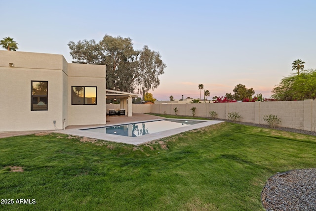6761 E Juniper Ave, Scottsdale, AZ 85254 - yard at dusk featuring a fenced backyard and a patio area