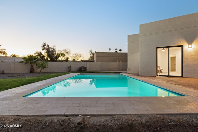 6761 E Juniper Ave, Scottsdale, AZ 85254 - pool at dusk with a fenced in pool, a patio area, and a fenced backyard