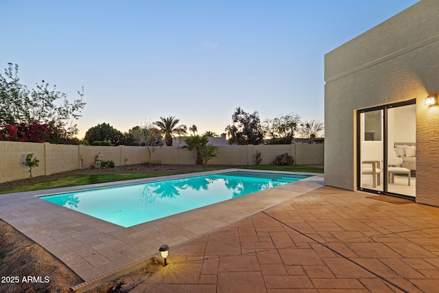 6761 E Juniper Ave, Scottsdale, AZ 85254 - pool at dusk featuring a fenced in pool, a patio area, and a fenced backyard