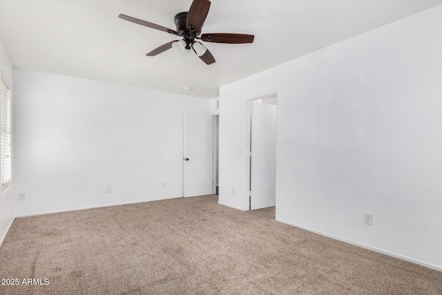 carpeted empty room featuring ceiling fan