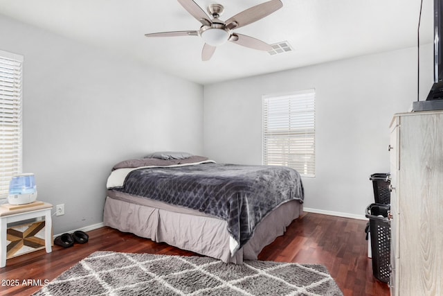 bedroom with dark hardwood / wood-style flooring and ceiling fan