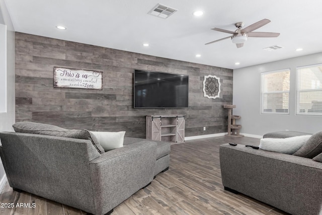 living room with ceiling fan and wood-type flooring