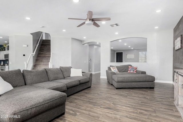 living room with ceiling fan and wood-type flooring