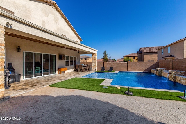 view of pool featuring pool water feature and a patio area