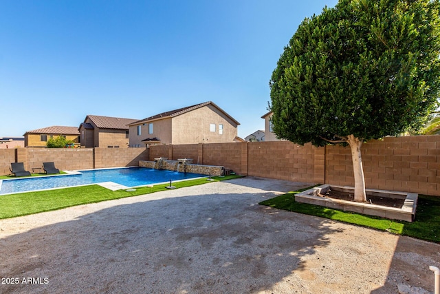 view of yard with a fenced in pool, a patio, and pool water feature