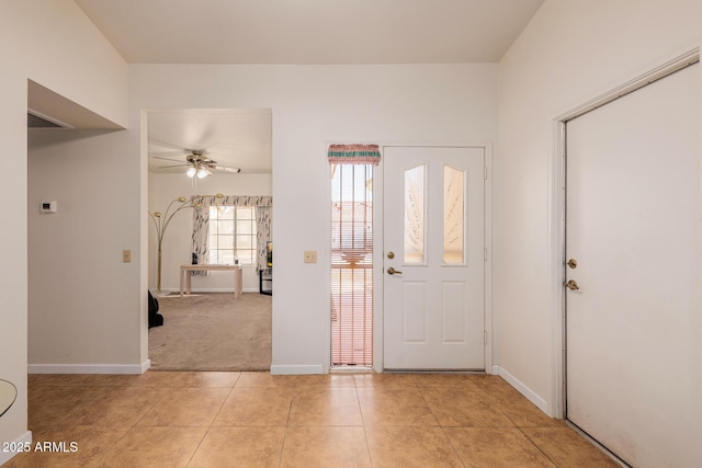 tiled foyer with ceiling fan