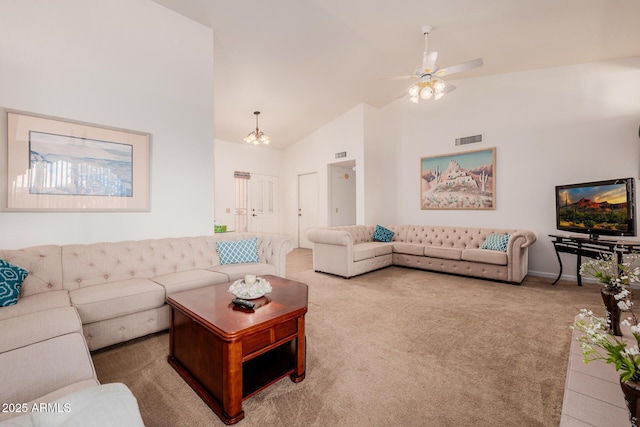 carpeted living room with ceiling fan and high vaulted ceiling