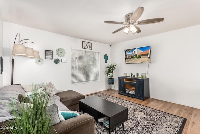 living room with wood-type flooring and ceiling fan