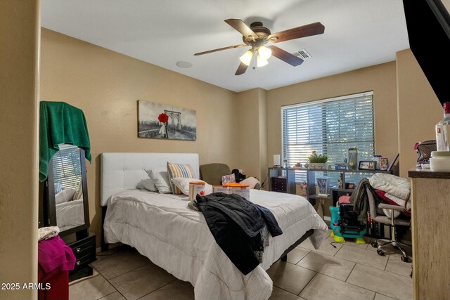 bedroom with light tile patterned floors and ceiling fan